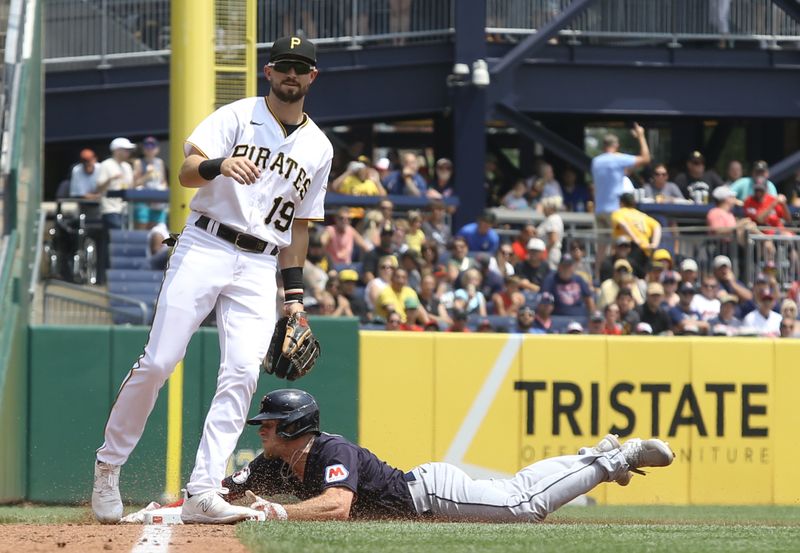 Jul 19, 2023; Pittsburgh, Pennsylvania, USA;  Cleveland Guardians center fielder Myles Straw (right) steals third base without a throw on a double steal as Pittsburgh Pirates third baseman Jared Triolo (19) reacts during the fifth inning at PNC Park. Mandatory Credit: Charles LeClaire-USA TODAY Sports