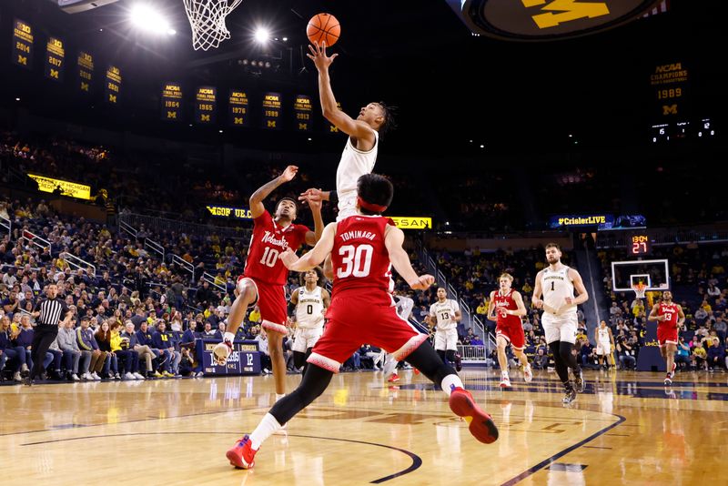Feb 8, 2023; Ann Arbor, Michigan, USA;  Michigan Wolverines guard Kobe Bufkin (2) shoots on Nebraska Cornhuskers guard Jamarques Lawrence (10) and guard Keisei Tominaga (30) in the first half at Crisler Center. Mandatory Credit: Rick Osentoski-USA TODAY Sports