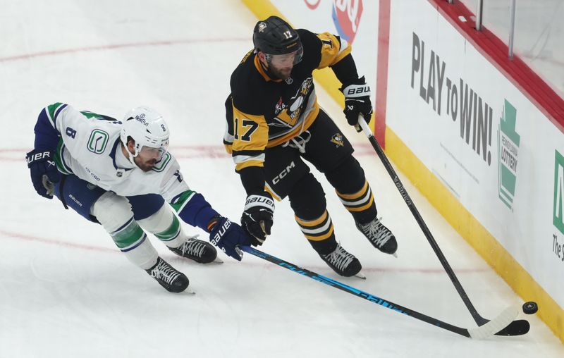 Oct 21, 2025; Pittsburgh, Pennsylvania, USA;  Vancouver Canucks right wing Conor Garland (8) and Pittsburgh Penguins right wing Bryan Rust (17) chase the puck during the second period at PPG Paints Arena. Mandatory Credit: Charles LeClaire-Imagn Images