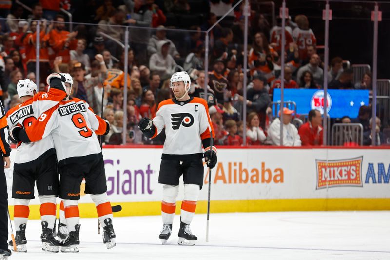 Oct 23, 2024; Washington, District of Columbia, USA; Philadelphia Flyers right wing Matvei Michkov (39) celebrates with teammates after scoring a goal against the Washington Capitals in the third period at Capital One Arena. Mandatory Credit: Geoff Burke-Imagn Images