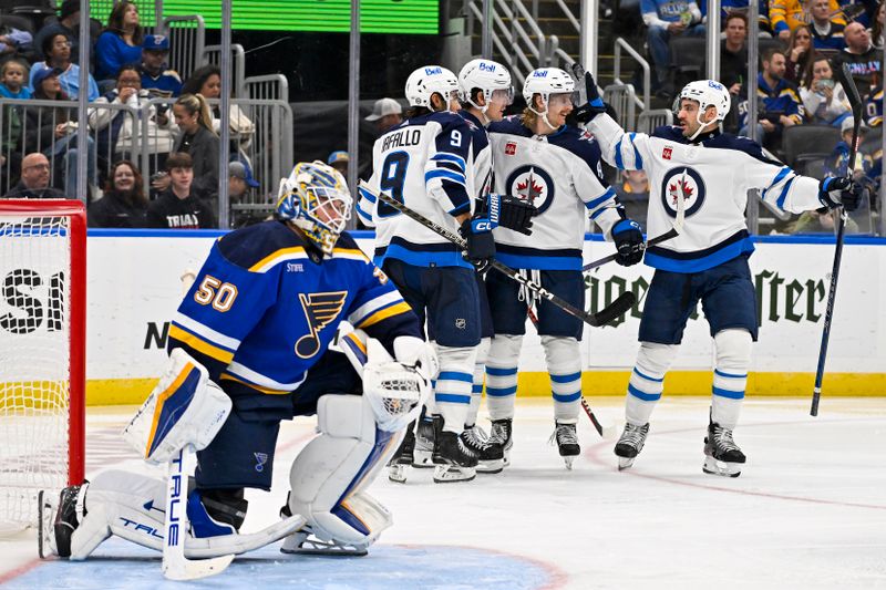 Nov 7, 2023; St. Louis, Missouri, USA;  Winnipeg Jets left wing Kyle Connor (81) celebrates with teammates after scoring against St. Louis Blues goaltender Jordan Binnington (50) during the third period at Enterprise Center. Mandatory Credit: Jeff Curry-USA TODAY Sports