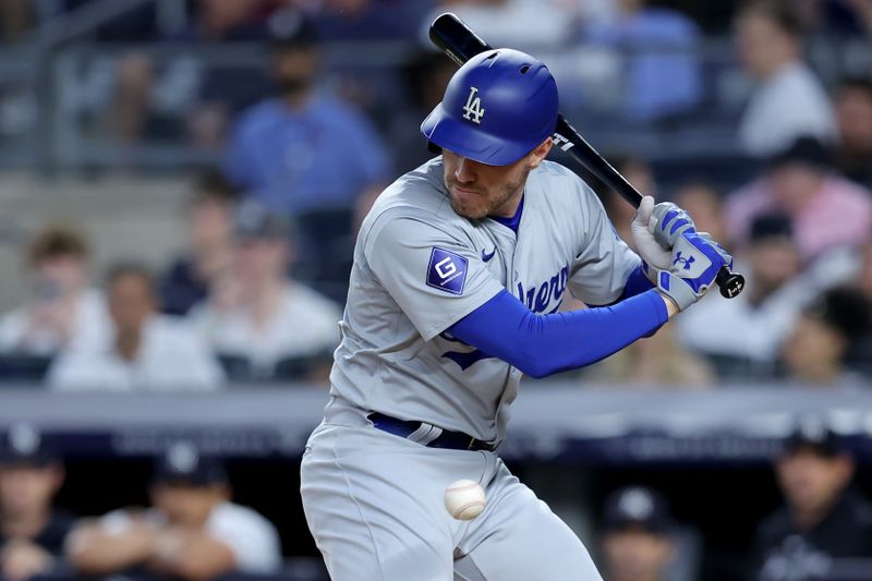 Jun 7, 2024; Bronx, New York, USA; Los Angeles Dodgers first baseman Freddie Freeman (5) is hit by a pitch during the sixth inning against the New York Yankees at Yankee Stadium. Mandatory Credit: Brad Penner-USA TODAY Sports