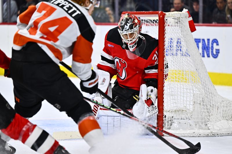 Apr 13, 2024; Philadelphia, Pennsylvania, USA; New Jersey Devils goalie Kaapo Kahkonen (31) defends the net against Philadelphia Flyers right wing Owen Tippett (74) in the first period at Wells Fargo Center. Mandatory Credit: Kyle Ross-USA TODAY Sports