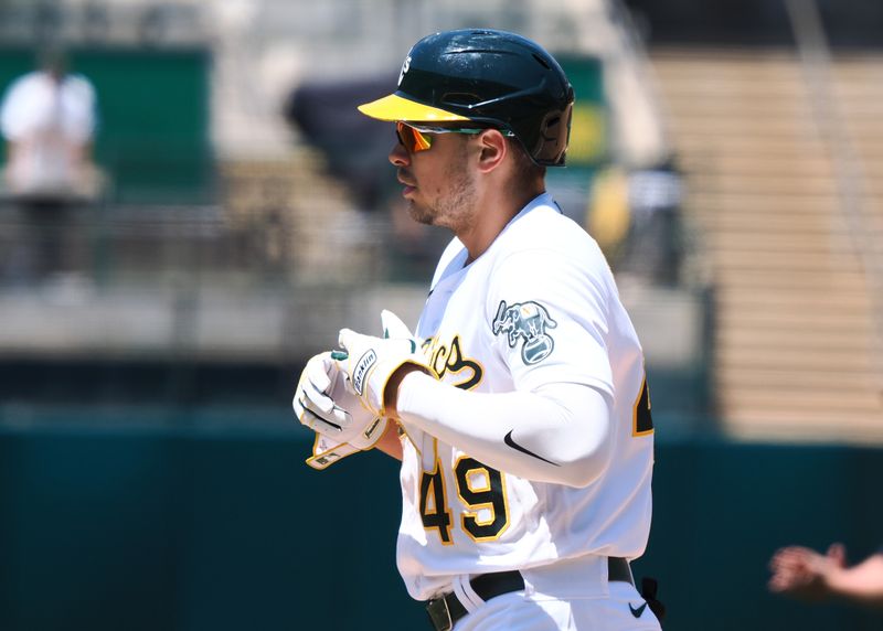 Jun 15, 2023; Oakland, California, USA; Oakland Athletics first baseman Ryan Noda (49) removes his glove after hitting an RBI single against the Tampa Bay Rays during the fifth inning at Oakland-Alameda County Coliseum. Mandatory Credit: Kelley L Cox-USA TODAY Sports