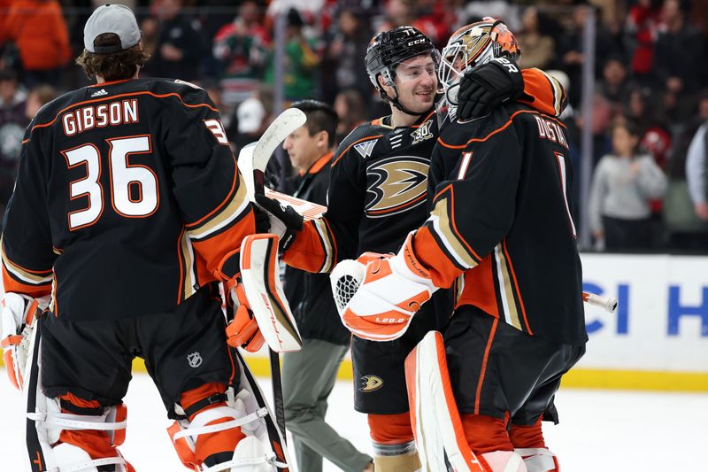 Mar 1, 2024; Anaheim, California, USA; Anaheim Ducks goaltender Lukas Dostal (1) celebrates with right wing Frank Vatrano (77) after defeating the New Jersey Devils 4-3 at Honda Center. Mandatory Credit: Kiyoshi Mio-USA TODAY Sports