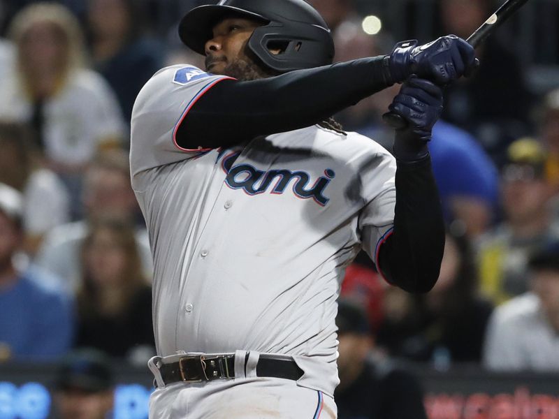 Sep 30, 2023; Pittsburgh, Pennsylvania, USA; Miami Marlins first baseman Josh Bell (9) hits a two run double against the Pittsburgh Pirates during the eighth inning at PNC Park. Mandatory Credit: Charles LeClaire-USA TODAY Sports