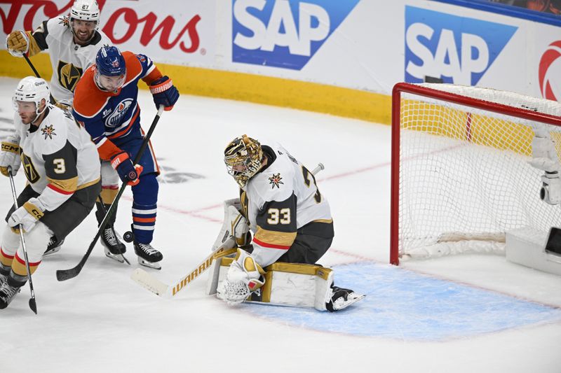 May 10, 2025; Edmonton, Alberta, CAN; Edmonton Oilers left winger Zach Hyman (18)  goes for a shot on Vegas Golden Knights goalie Adin Hill (33) with Knights defenceman Brayden McNabb (3) and Knights defenceman Shea Theodore (27) looking on during the third period in game three of the second round of the 2025 Stanley Cup Playoffs at Rogers Place. Mandatory Credit: Walter Tychnowicz-Imagn Images