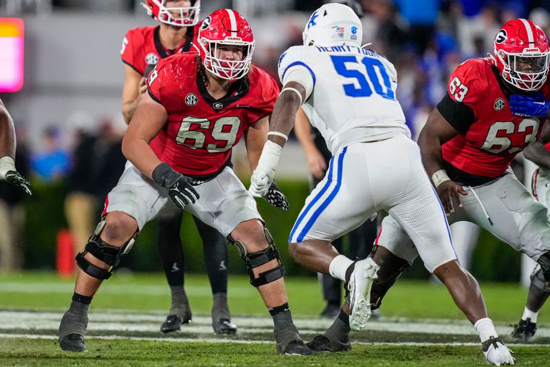 Oct 7, 2023; Athens, Georgia, USA; Georgia Bulldogs offensive lineman Tate Ratledge (69) blocks against Kentucky Wildcats defensive lineman Darrion Henry-Young (50) during the second half at Sanford Stadium. Mandatory Credit: Dale Zanine-USA TODAY Sports