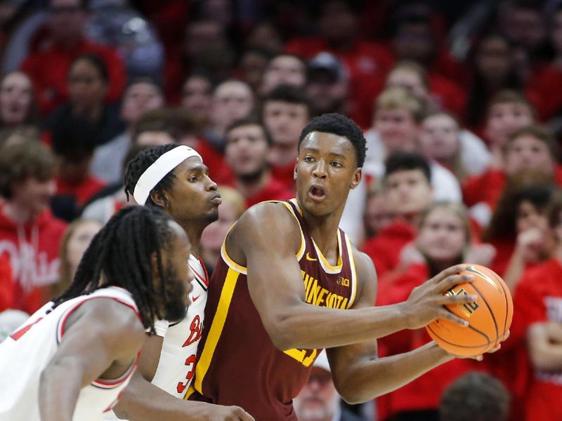 Dec 3, 2023; Columbus, Ohio, USA;  Minnesota Golden Gophers forward Pharrel Payne (21) looks to pass as Ohio State Buckeyes center Felix Okpara (34) defends him on the play during the second half at Value City Arena. Mandatory Credit: Joseph Maiorana-USA TODAY Sports