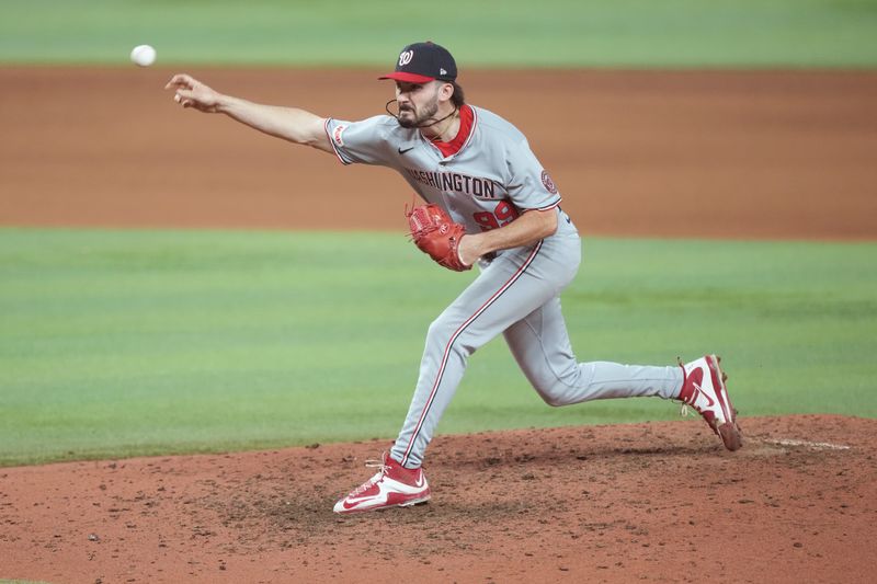 Sep 11, 2025; Miami, Florida, USA;  Washington Nationals relief pitcher Cole Henry (99) pitches in the seventh inning against the Miami Marlins at loanDepot Park. Mandatory Credit: Jim Rassol-Imagn Images