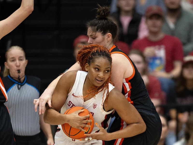 Jan 21, 2024; Stanford, California, USA; Stanford Cardinal forward Kiki Iriafen (left) wrestles the ball away from Oregon State Beavers forward Raegan Beers (15) during the first quarter at Maples Pavilion. Mandatory Credit: D. Ross Cameron-USA TODAY Sports