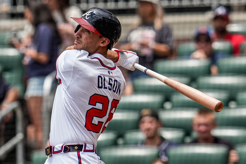 Jun 5, 2025; Cumberland, Georgia, USA; Atlanta Braves first baseman Matt Olson (28) hits a double to drive in a run against the Arizona Diamondbacks during the third inning at Truist Park. Mandatory Credit: Dale Zanine-Imagn Images