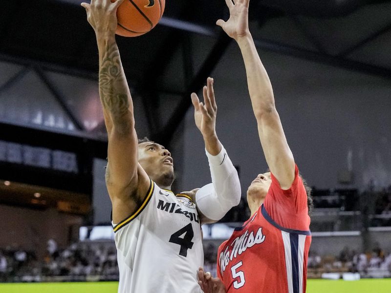 Mar 4, 2023; Columbia, Missouri, USA; Missouri Tigers guard DeAndre Gholston (4) shoots as Mississippi Rebels guard James White (5) defends during the first half at Mizzou Arena. Mandatory Credit: Denny Medley-USA TODAY Sports