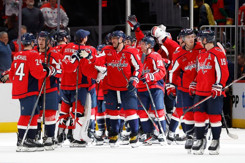 Oct 16, 2023; Washington, District of Columbia, USA; Washington Capitals players celebrate after their game against the Calgary Flames at Capital One Arena. Mandatory Credit: Geoff Burke-USA TODAY Sports