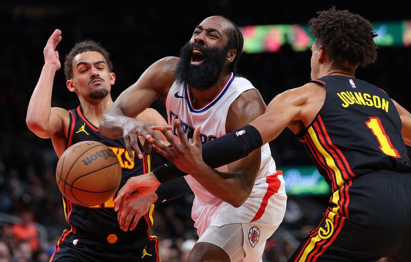 ATLANTA, GEORGIA - FEBRUARY 05:  James Harden #1 of the LA Clippers draws a foul as he drives between Trae Young #11 and h1during the fourth quarter at State Farm Arena on February 05, 2024 in Atlanta, Georgia.  NOTE TO USER: User expressly acknowledges and agrees that, by downloading and/or using this photograph, user is consenting to the terms and conditions of the Getty Images License Agreement.  (Photo by Kevin C. Cox/Getty Images)