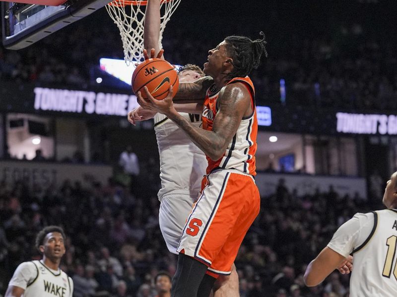 Feb 28, 2026; Winston-Salem, North Carolina, USA; Syracuse Orange forward William Kyle III (42) drives to the basket defended by Wake Forest Demon Deacons forward Cooper Schwieger (13) during the second half at Lawrence Joel Veterans Memorial Coliseum. Mandatory Credit: Jim Dedmon-Imagn Images