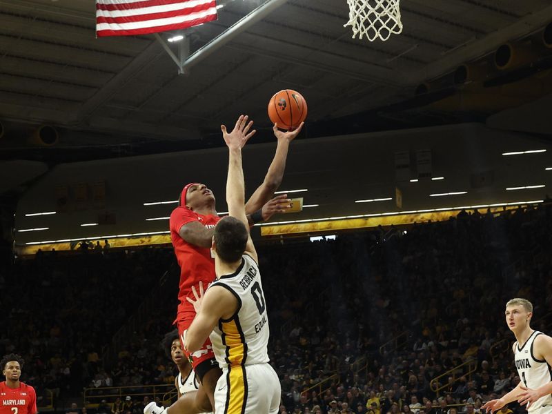 Jan 15, 2023; Iowa City, Iowa, USA; Maryland Terrapins forward Julian Reese (10) scores over the hand of Iowa Hawkeyes forward Filip Rebraca (0) at Carver-Hawkeye Arena. Mandatory Credit: Reese Strickland-USA TODAY Sports