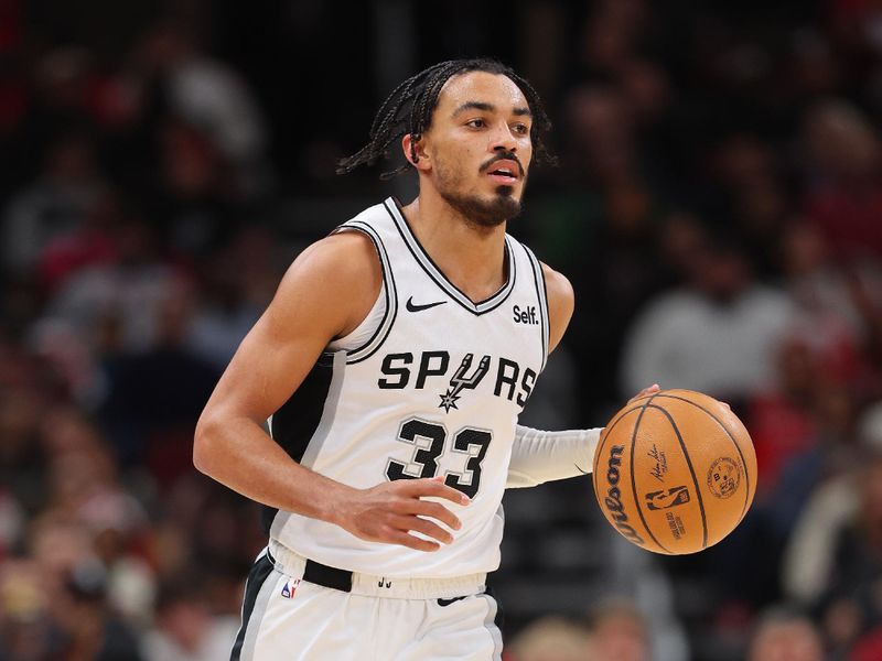 CHICAGO, ILLINOIS - DECEMBER 21: Tre Jones #33 of the San Antonio Spurs dribbles up the court against the Chicago Bulls during the first half at the United Center on December 21, 2023 in Chicago, Illinois. NOTE TO USER: User expressly acknowledges and agrees that, by downloading and or using this photograph, User is consenting to the terms and conditions of the Getty Images License Agreement.  (Photo by Michael Reaves/Getty Images)