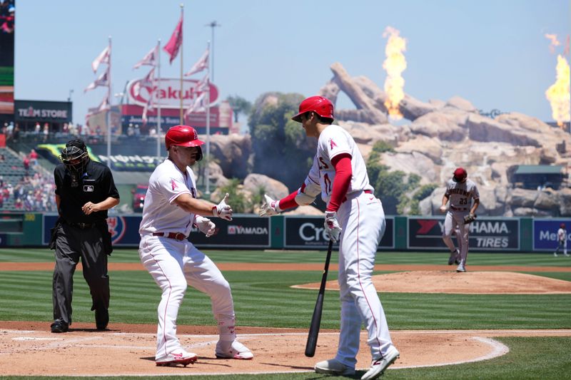 Jul 2, 2023; Anaheim, California, USA; Los Angeles Angels center fielder Mike Trout (27) celebrates with designated hitter Shohei Ohtani (17) after hitting a solo home run in the first inning against Arizona Diamondbacks starting pitcher Zac Gallen (23) at Angel Stadium. Mandatory Credit: Kirby Lee-USA TODAY Sports
