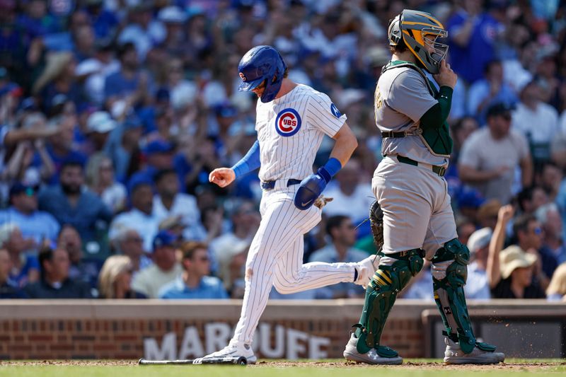 Sep 18, 2024; Chicago, Illinois, USA; Chicago Cubs second baseman Nico Hoerner (2) scores against the Oakland Athletics during the fifth inning at Wrigley Field. Mandatory Credit: Kamil Krzaczynski-Imagn Images