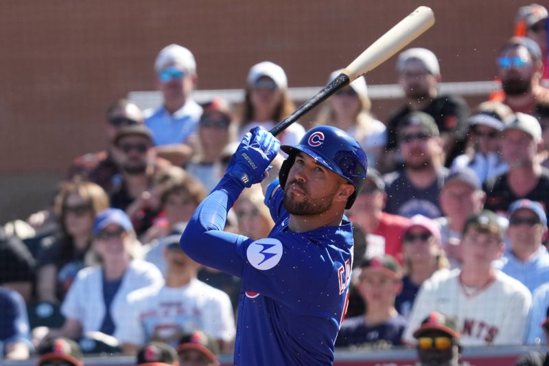 Feb 22, 2026; Scottsdale, Arizona, USA; Chicago Cubs left fielder Dylan Carlson (5) hits against the San Francisco Giants in the second inning at Scottsdale Stadium. Mandatory Credit: Rick Scuteri-Imagn Images