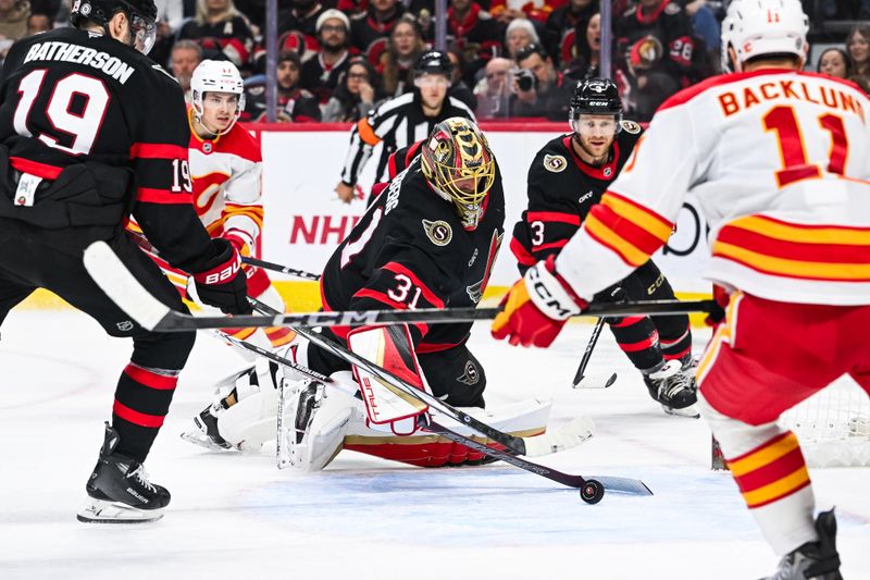 Nov 25, 2024; Ottawa, Ontario, CAN; Ottawa Senators goalie Anton Forsberg (31) makes a save against the Calgary Flames during the second period at Canadian Tire Centre. Mandatory Credit: David Kirouac-Imagn Images