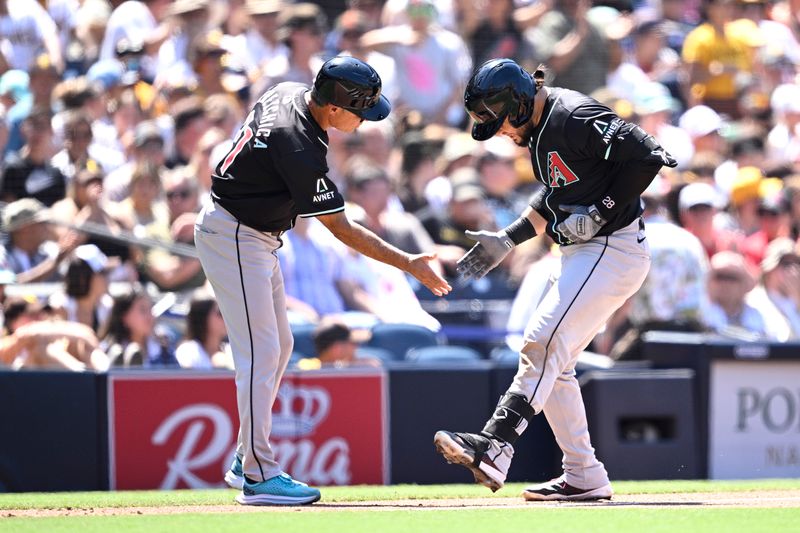 Jul 7, 2024; San Diego, California, USA; Arizona Diamondbacks third baseman Eugenio Suarez (28) celebrates with third base coach Tony Perezchica (21) after hitting a two-run home run against the San Diego Padres during the seventh inning at Petco Park. Mandatory Credit: Orlando Ramirez-USA TODAY Sports