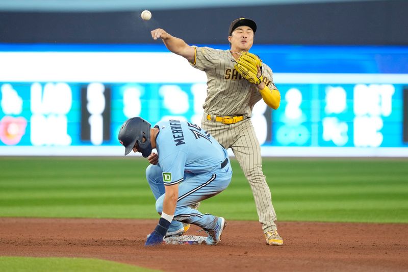 Jul 18, 2023; Toronto, Ontario, CAN; San Diego Padres second baseman Ha-Seong Kim (7) turns a double play on Toronto Blue Jays second baseman Whit Merrifield (not pictured) and catcher Danny Jansen (not pictured)  during the fourth inning at Rogers Centre. Mandatory Credit: John E. Sokolowski-USA TODAY Sports