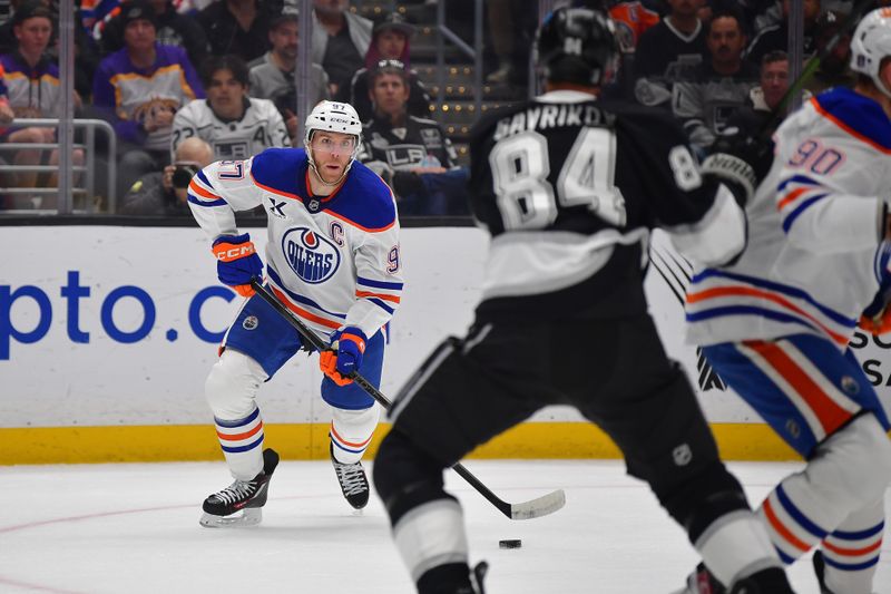 Apr 29, 2025; Los Angeles, California, USA; Edmonton Oilers center Connor McDavid (97) moves the puck against the Los Angeles Kings during the first period in game five of the first round of the 2025 Stanley Cup Playoffs at Crypto.com Arena. Mandatory Credit: Gary A. Vasquez-Imagn Images