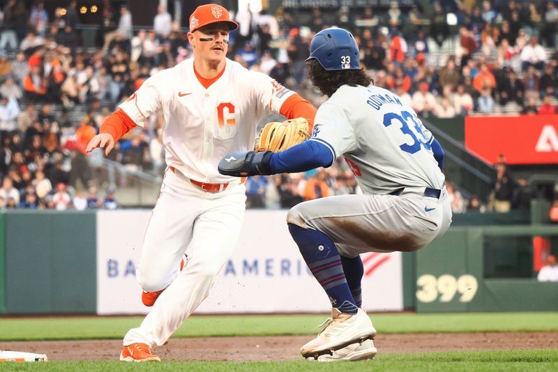 May 14, 2024; San Francisco, California, USA; San Francisco Giants third baseman Matt Chapman (26) tags out Los Angeles Dodgers center fielder James Outman (33) to start the double play during the third inning at Oracle Park. Mandatory Credit: Kelley L Cox-USA TODAY Sports