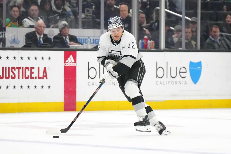 Apr 13, 2024; Los Angeles, California, USA; LA Kings left wing Trevor Moore (12) handles the puck against the Anaheim Ducks in the second period at Crypto.com Arena. Mandatory Credit: Kirby Lee-USA TODAY Sports