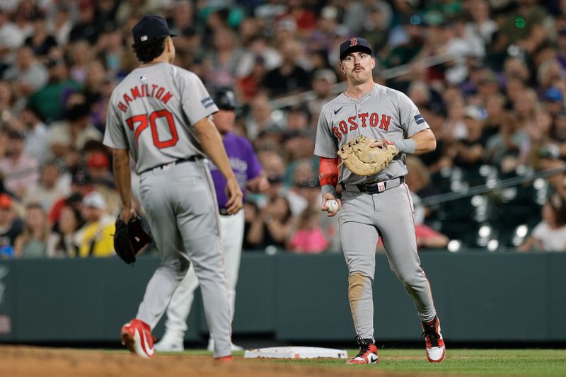 Jul 22, 2024; Denver, Colorado, USA; Boston Red Sox first baseman Romy Gonzalez (23) reacts with shortstop David Hamilton (70) after a play in the seventh inning against the Colorado Rockies at Coors Field. Mandatory Credit: Isaiah J. Downing-USA TODAY Sports