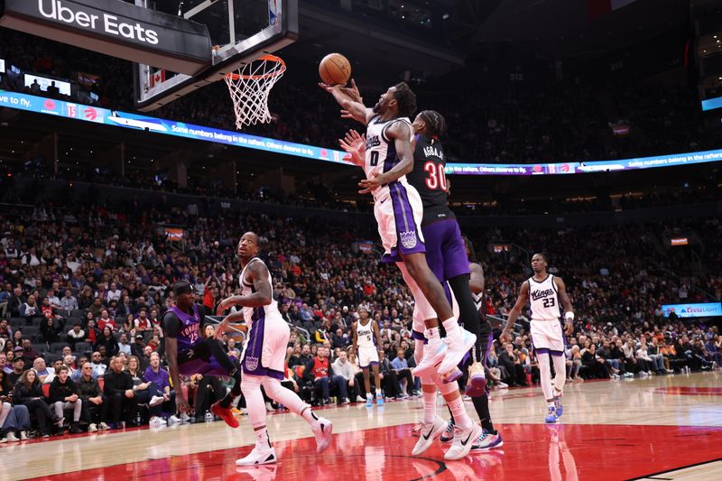 TORONTO, CANADA - NOVEMBER 2: Malik Monk #0 of the Sacramento Kings goes up for the rebound during the game against the Toronto Raptors on November 2, 2024 at the Scotiabank Arena in Toronto, Ontario, Canada.  NOTE TO USER: User expressly acknowledges and agrees that, by downloading and or using this Photograph, user is consenting to the terms and conditions of the Getty Images License Agreement.  Mandatory Copyright Notice: Copyright 2024 NBAE (Photo by Joe Murphy/NBAE via Getty Images)