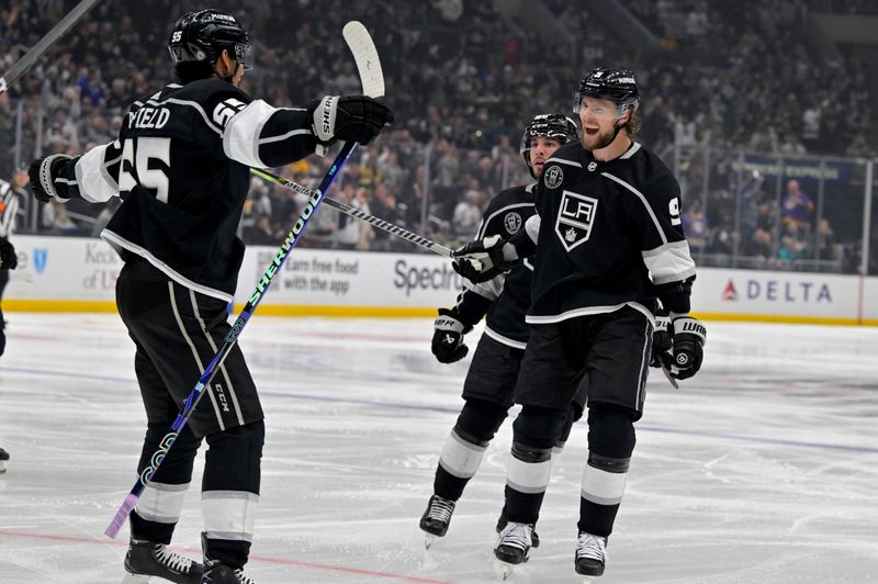 Feb 11, 2023; Los Angeles, California, USA;  Los Angeles Kings right wing Adrian Kempe (9) is congratulated by center Quinton Byfield (55) after his second goal of the game against the Pittsburgh Penguins at Crypto.com Arena. Mandatory Credit: Jayne Kamin-Oncea-USA TODAY Sports