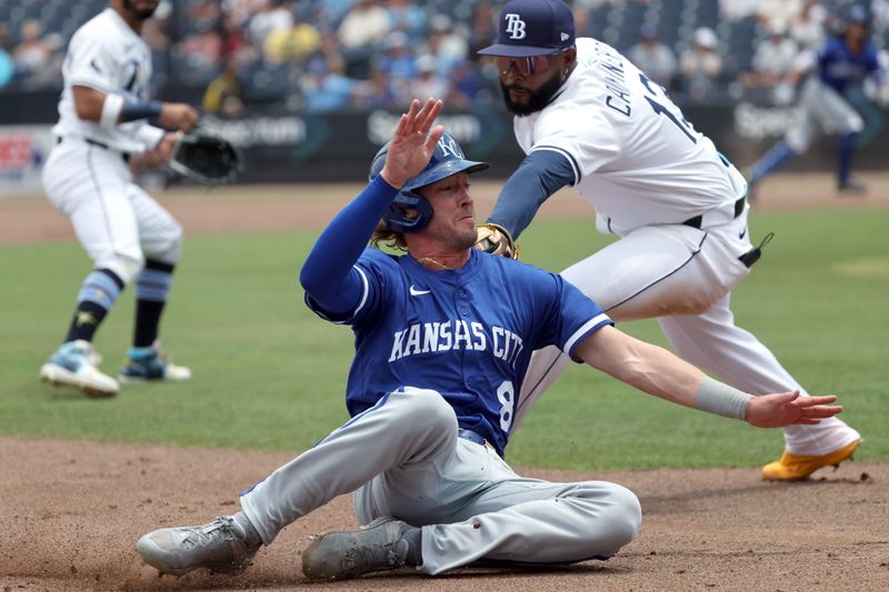 May 1, 2025; St. Petersburg, Florida, USA;  Kansas City Royals outfielder Drew Waters (8) slides into third base as Tampa Bay Rays third base Junior Caminero (13) tags him out during the third inning at George M. Steinbrenner Field. Mandatory Credit: Kim Klement Neitzel-Imagn Images