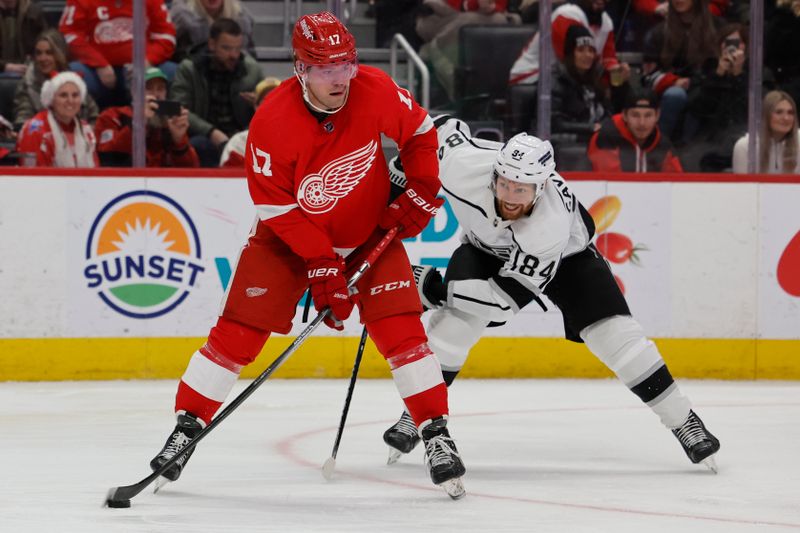 Jan 13, 2024; Detroit, Michigan, USA;  Detroit Red Wings right wing Daniel Sprong (17) skates with the puck chased by Los Angeles Kings defenseman Vladislav Gavrikov (84) in the second period at Little Caesars Arena. Mandatory Credit: Rick Osentoski-USA TODAY Sports