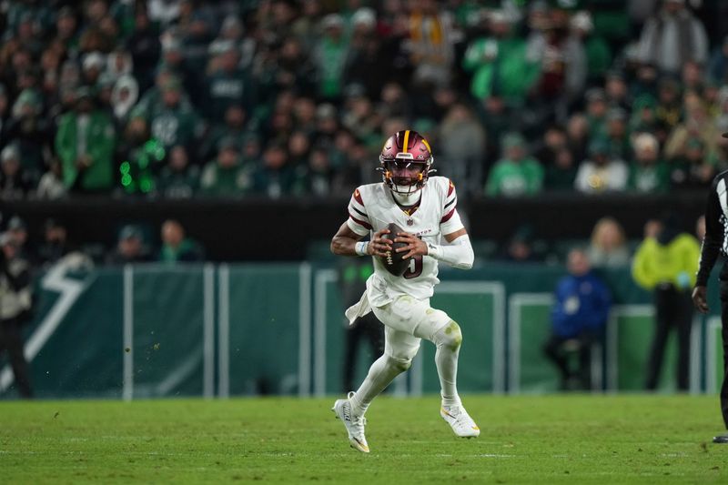 Washington Commanders quarterback Jayden Daniels scrambles during the first half of an NFL football game against the Philadelphia Eagles Thursday, Nov. 14, 2024, in Philadelphia. (AP Photo/Matt Slocum)