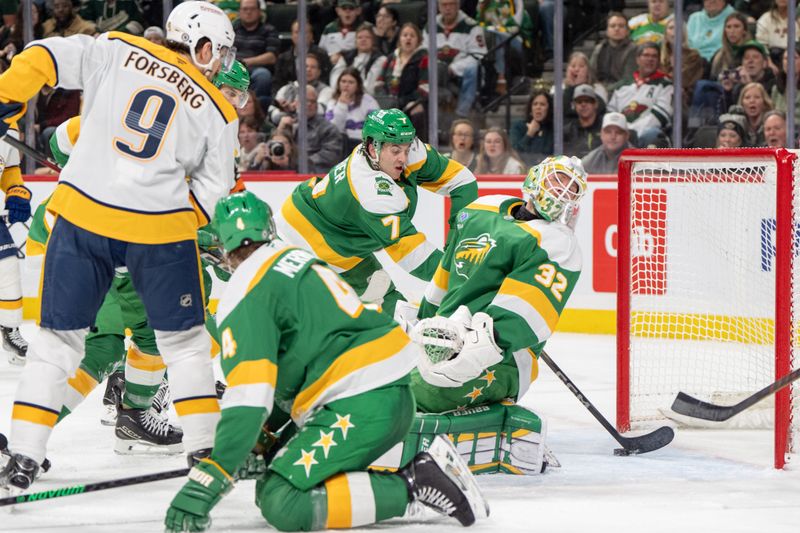 Dec 31, 2024; Saint Paul, Minnesota, USA; Minnesota Wild defenseman Brock Faber (7) and goaltender Filip Gustavsson (32) defend against the Nashville Predators in the third period at Xcel Energy Center. Mandatory Credit: Matt Blewett-Imagn Images