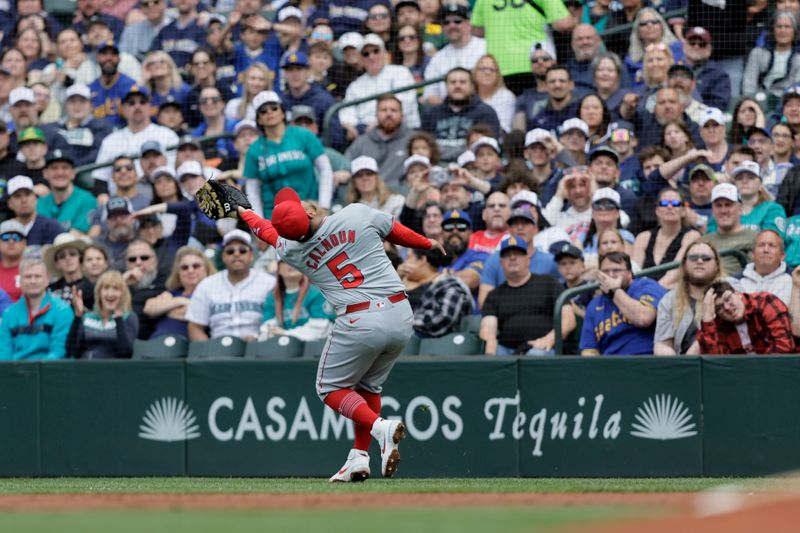 Jun 1, 2024; Seattle, Washington, USA;  Los Angeles Angels first baseman Willie Calhoun (5) catches a pop fly for an out hit by Seattle Mariners catcher Cal Raleigh during the first inning at T-Mobile Park. Mandatory Credit: John Froschauer-USA TODAY Sports