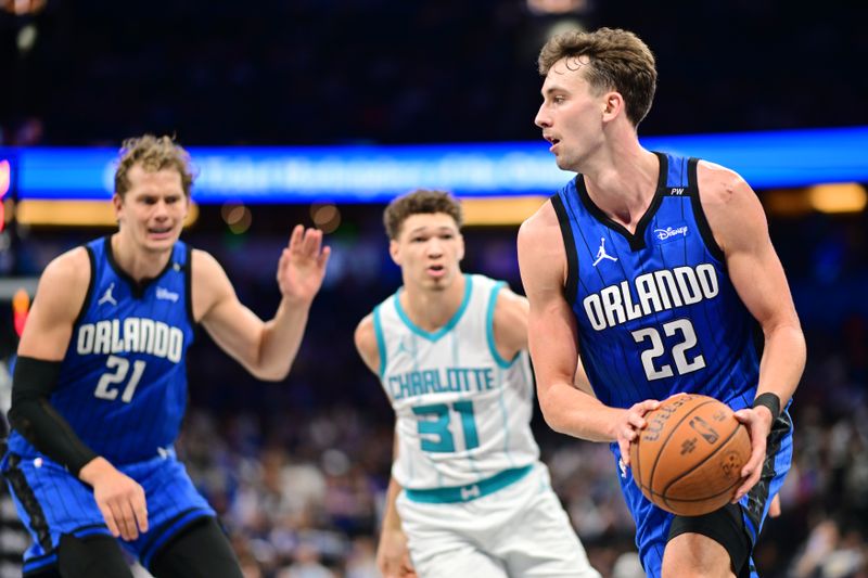 ORLANDO, FLORIDA - NOVEMBER 12: Franz Wagner #22 of the Orlando Magic looks to pass the ball to Moritz Wagner #21 in the second half against the Charlotte Hornets during an Emirates NBA Cup game at Kia Center on November 12, 2024 in Orlando, Florida. NOTE TO USER: User expressly acknowledges and agrees that, by downloading and or using this photograph, User is consenting to the terms and conditions of the Getty Images License Agreement. (Photo by Julio Aguilar/Getty Images)