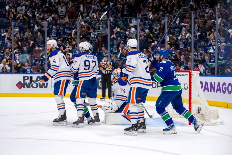 May 20, 2024; Vancouver, British Columbia, CAN; Edmonton Oilers defenseman Mattias Ekholm (14) and forward Connor McDavid (97) and goalie Stuart Skinner (74) and defenseman Evan Bouchard (2) react as Vancouver Canucks forward Nils Hoglander (21) celebrates a goal scored by defenseman Filip Hronek (17) during the third period in game seven of the second round of the 2024 Stanley Cup Playoffs at Rogers Arena. Mandatory Credit: Bob Frid-USA TODAY Sports