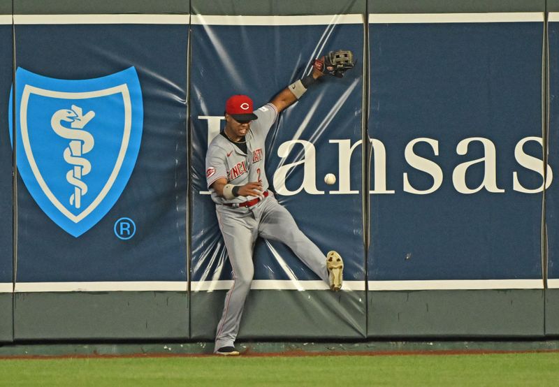 Jun 14, 2023; Kansas City, Missouri, USA;  Cincinnati Reds center fielder Jose Barrero (2) hits the wall after attempting to catch a triple hit by Kansas City Royals Maikel Garcia (not pictured) in the seventh inning at Kauffman Stadium. Mandatory Credit: Peter Aiken-USA TODAY Sports