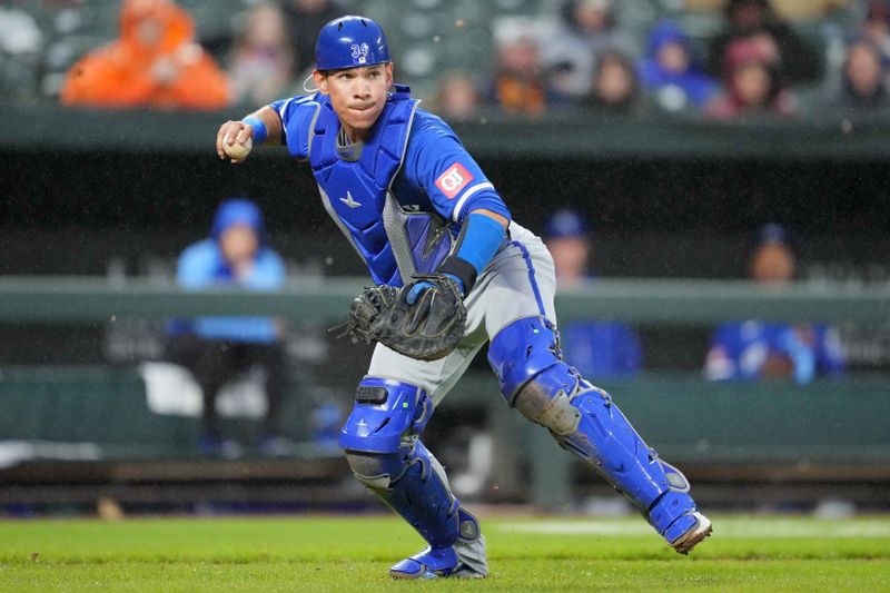 Apr 3, 2024; Baltimore, Maryland, USA; Kansas City Royals catcher Freddy Fermin (34) throws out Baltimore Orioles shortstop Gunnar Henderson (not shown) following a swinging bunt in the fourth inning at Oriole Park at Camden Yards. Mandatory Credit: Mitch Stringer-USA TODAY Sports