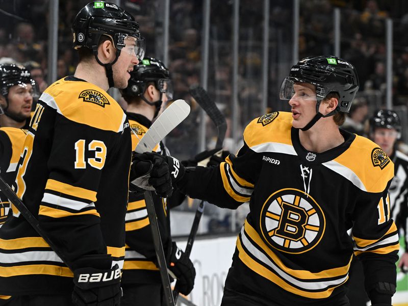 Jan 14, 2025; Boston, Massachusetts, USA; Boston Bruins center Trent Frederic (11) celebrates with center Charlie Coyle (13) after scoring a goal against the Tampa Bay Lightning during the first period at the TD Garden. Mandatory Credit: Brian Fluharty-Imagn Images