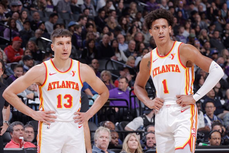 SACRAMENTO, CA - JANUARY 22: Bogdan Bogdanovic #13 and Jalen Johnson #1 of the Atlanta Hawks looks on during the game against the Sacramento Kings on January 22, 2024 at Golden 1 Center in Sacramento, California. NOTE TO USER: User expressly acknowledges and agrees that, by downloading and or using this Photograph, user is consenting to the terms and conditions of the Getty Images License Agreement. Mandatory Copyright Notice: Copyright 2024 NBAE (Photo by Rocky Widner/NBAE via Getty Images)