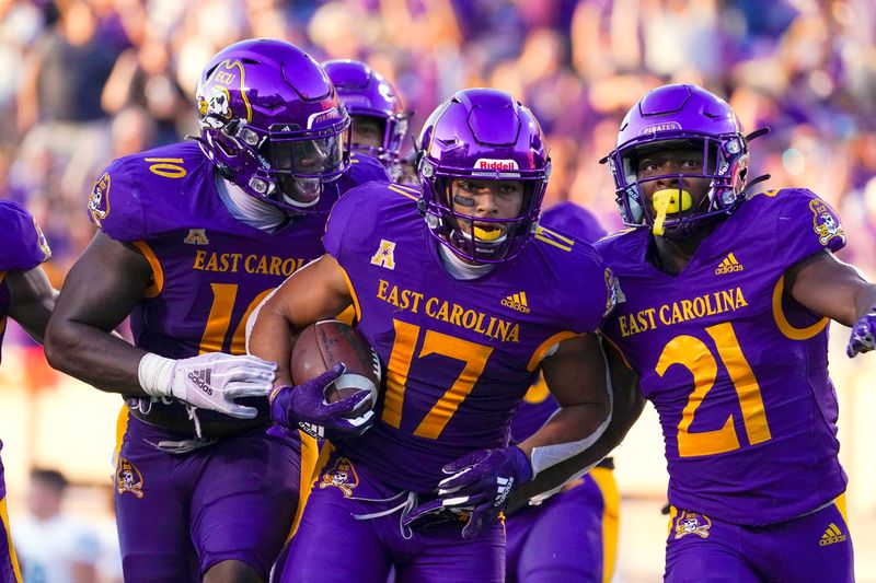 Oct 2, 2021; Greenville, North Carolina, USA;  East Carolina Pirates safety Warren Saba (17) celebrates with linebacker Xavier Smith (10) and cornerback Ja'Quan McMillian (21) after making an interception against the Tulane Green Wave during the second half during the second half at Dowdy-Ficklen Stadium. Mandatory Credit: James Guillory-USA TODAY Sports