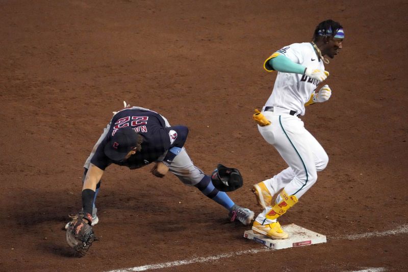 Jun 18, 2023; Phoenix, Arizona, USA; Arizona Diamondbacks shortstop Geraldo Perdomo (2) beats a throw to Cleveland Guardians first baseman Josh Naylor (22) for a single during the fifth inning at Chase Field. Mandatory Credit: Joe Camporeale-USA TODAY Sports