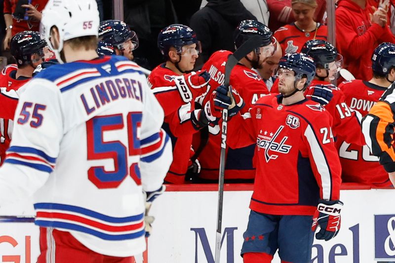 Jan 4, 2025; Washington, District of Columbia, USA; Washington Capitals center Connor McMichael (24) celebrates with teammates after scoring a goal against the New York Rangers in the second period at Capital One Arena. Mandatory Credit: Geoff Burke-Imagn Images