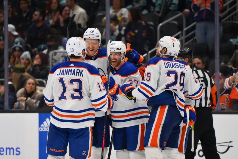 Mar 2, 2024; Seattle, Washington, USA; The Edmonton Oilers celebrate after a goal scored by defenseman Brett Kulak (27) during the third period against the Seattle Kraken at Climate Pledge Arena. Mandatory Credit: Steven Bisig-USA TODAY Sports