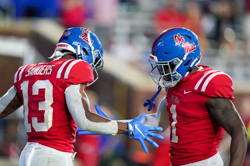 Sep 18, 2021; Oxford, Mississippi, USA; Mississippi Rebels wide receiver Braylon Sanders (13) and Mississippi Rebels wide receiver Jonathan Mingo (1) celebrate after Sanders scores a touchdown against Tulane Green Wave at Vaught-Hemingway Stadium. Mandatory Credit: Marvin Gentry-USA TODAY Sports